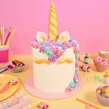 Unicorn Cake by Crumbs & Doilies with golden horn, pastel buttercream mane, and delicate sugarcraft decorations.
